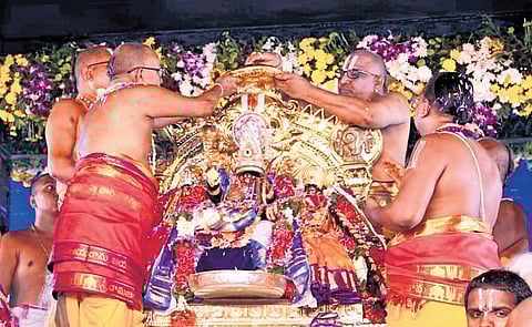 Priests perform rituals as part of the Pattabhishekam Mahotsavam
