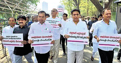 BRS MLAs protest outside the Assembly in Hyderabad on Sunday demanding immediate dismissal of Minister Ponguleti Srinivasa Reddy