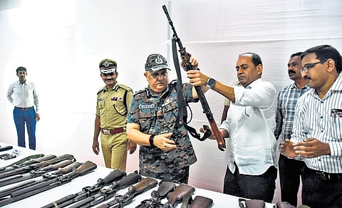 DGP Harish Kumar Gupta takes a look at the ammunition recovered from the surrendered Maoists, at a press conference in Vijayawada