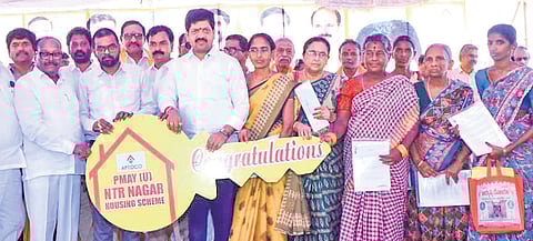 Excise Minister Kollu Ravindra distributes TIDCO houses to beneficiaries in Machilipatnam on Monday