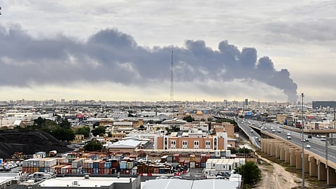 Smoke rises from Kuwait international airport after a drone strike on fuel storage in Kuwait City, Kuwait.
