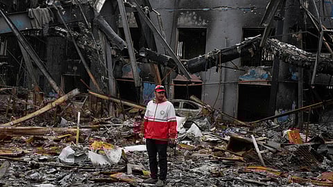 A member of the Iranian Red Crescent Society stands at Hypercar, an auto service center, amid damages which according to the company's officials were caused by strikes on March 1, in Tehran, Iran, Saturday, March 28, 2026.