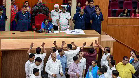 Opposition MLAs of Odisha Legislative Assembly stage a protest inside the House during the ongoing Budget Session of the state assembly, in Bhubaneswar, Tuesday, March 31, 2026.