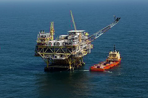 A supply vessel boat sits near an oil rig in the Gulf of Mexico, off the coast of Louisiana. April 10, 2011.