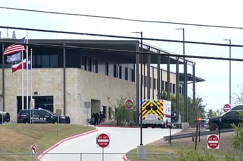 This image taken from video provided by KSAT shows first responders outside after a student shot a teacher at Hill Country College Preparatory High School, Monday, March 30, 2026, in Bulverde, Texas.