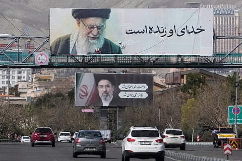 Vehicles drive under billboards showing portraits of the late Iranian Supreme Leader Ayatollah Ali Khamenei, foreground, and his son Ayatollah Mojtaba Khamenei, the successor to him, along a highway in Tehran, Iran, Tuesday, March 24, 2026.