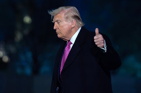 President Donald Trump waves to the media as he walks on the South Lawn upon his arrival to the White House, Sunday, March 29, 2026, in Washington.