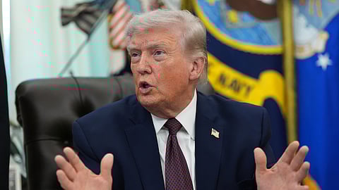 US President Donald Trump answers questions from reporters after signing an executive order in the Oval Office of the White House Tuesday, March 31, 2026, in Washington.