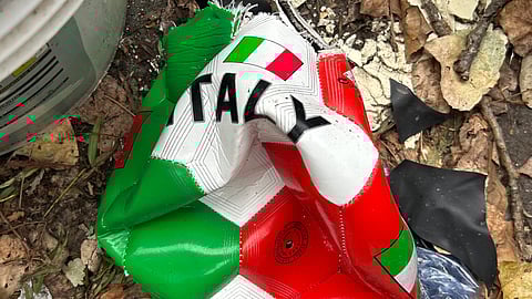 A broken soccer ball is pictured on a street in Rome, Wednesday, April 1, 2026.