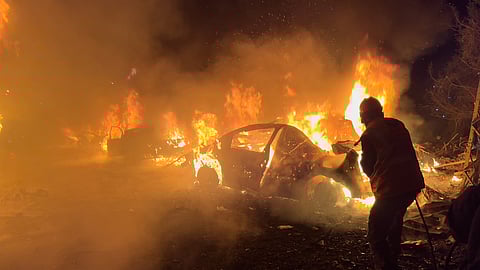 A firefighter extinguishes a car at the site of Israeli airstrikes in Beirut, Lebanon, Wednesday, April 1, 2026.