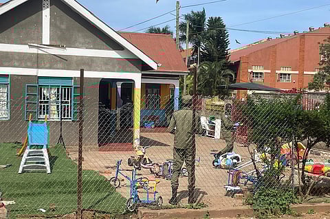 Uganda police officers stand at the crime scene after a man killed four children in a machete attack at the Gaba Early Childhood Development Program nursery school in Kampala, Uganda, Thursday, April 2, 2026.