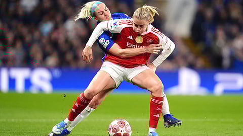 Arsenal's Alessia Russo, left, and Chelsea's Ellie Carpenter battle for the ball during the Women's Champions League quarterfinal second leg soccer match between Chelsea and Arsenal in London, Wednesday, April 1, 2026.