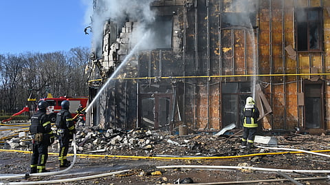 Ukrainian rescuers work to extinguish a fire in a damaged residential building following a drone attack in Kharkiv on April 2, 2026, amid the Russian invasion of Ukraine.