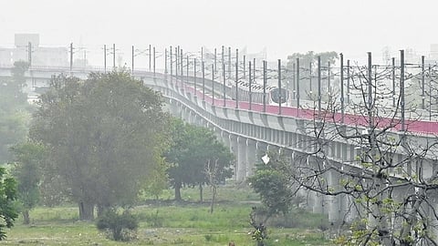A Metro train moves through haze during a sudden dust storm that swept through New Delhi on Friday morning.