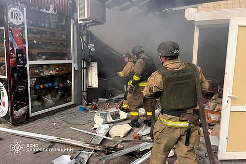 In this handout photograph taken and released by the State Emergency Service of Ukraine on April 4, 2026, firefighters put out a fire at the market following a strike in Nikopol, amid the Russian invasion of Ukraine.