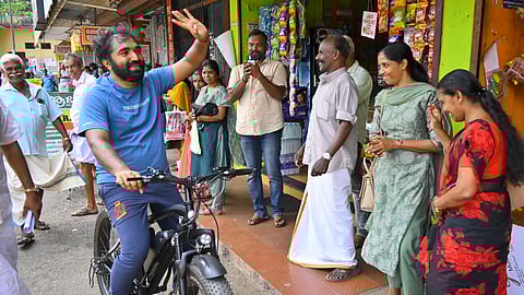 UDF candidate for Puthuppally, Chandy Oommen engaging with the voters on his cycle.