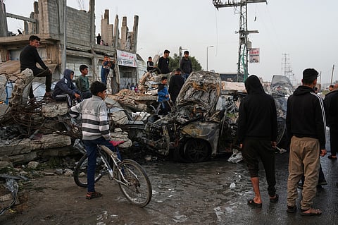 Palestinians inspect a vehicle struck by an Israeli airstrike in the Maghazi refugee camp in the central Gaza Strip, Saturday, April 4, 2026.