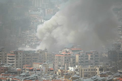 Smoke rises from the site of an Israeli airstrike that targeted an area in Beirut's southern suburbs, during haze on April 5, 2026.