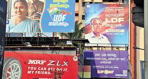 Three political parties contesting to lead Kerala in the Kerala Legislative Assembly election have displayed their slogans together at Vyttila main junction.