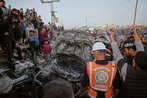 Palestinians inspect a vehicle struck by an Israeli airstrike in the Maghazi refugee camp in the central Gaza Strip, Saturday, April 4, 2026.