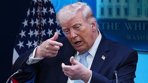 President Donald Trump pretends to aim a sniper gun while speaking with reporters in the James Brady Press Briefing Room at the White House, Monday, April 6, 2026, in Washington.