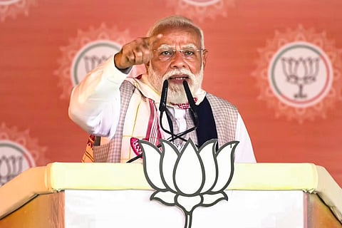 Prime Minister Narendra Modi gives an addressal during a public meeting ahead of the Assam Assembly elections, in Barpeta, Assam.