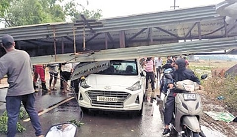 The car trapped under the welcome arch that fell during nor’wester in Athagarh