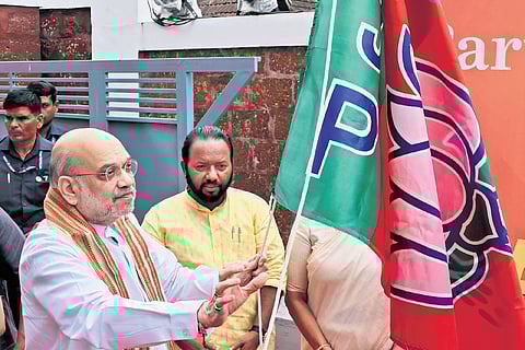 Union Home Minister Amit Shah hoisting the BJP flag at Mararji Bhavan in Thiruvananthapuram on Monday, marking the party’s Foundation Day celebrations.