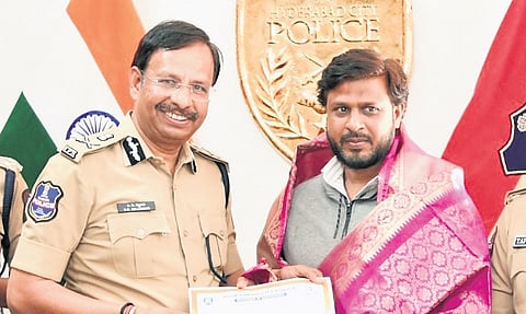 City police chief VC Sajjanar felicitates a man for rescuing an eight-year-old girl, in Hyderabad on Monday
