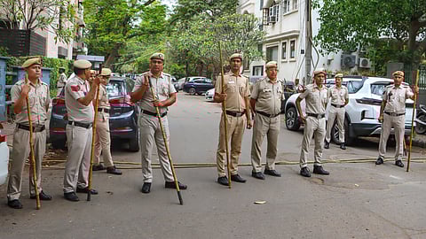 Police personnel stand guard outside Congress leader Pawan Khera's residence, at Nizamuddin area, in New Delhi, Tuesday, April 7, 2026.