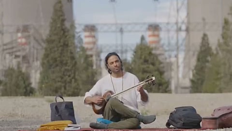Iranian musician Ali Ghasmari performs outside Damavand power plant after Trump threat to target key infra
