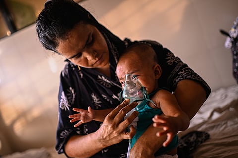 A mother administers a nebulizer treatment for her child suffering from measles at the Infectious Diseases Hospital in Dhaka, Bangladesh, Monday, April 6, 2026