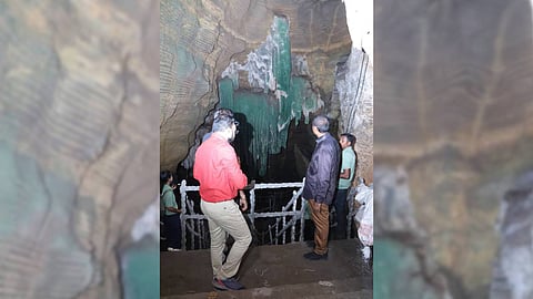 Visitors standing on staircase (permanent masonry) to watch ecologically fragile Green Caves in Bastar.