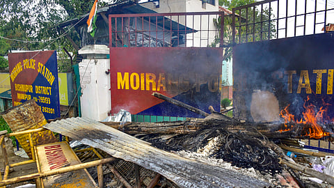 Charred remains lie in front of Moirang Police Station's entrance after police barricades were set ablaze by people in protest when two children were killed and their mother was injured in a bomb attack, in Bishnupur district, Manipur, Tuesday, April 7, 2026.