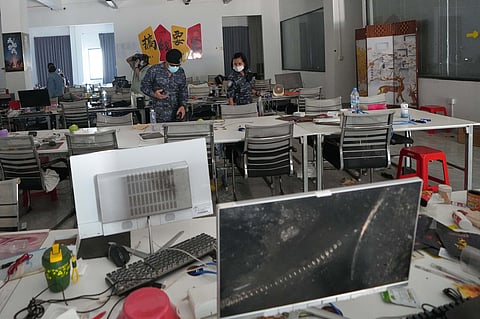 Thai soldiers inspect a work station at the scam compound in O'Smach, Cambodia, Tuesday, April 7, 2026.