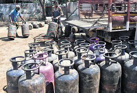 Workers load and unload commercial LPG cylinders at a godown in Cherlapally industrial area on Tuesday.