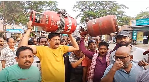 People protesting with empty LPG cylinders in Jagatsinghpur town.