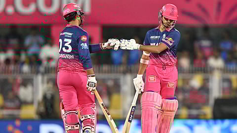 Rajasthan Royals' Indian cricket players Yashasvi Jaiswal and Vaibhav Sooryavanshi bump fists during the 2026 IPL T20 match between Rajasthan Royals and Mumbai Indians at the Barsapara Cricket Stadium in Guwahati on April 7, 2026.