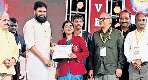 Deputy CM K Pawan Kalyan hands over a certificate to a student at the AU centenary mega cultural festival held in Visakhapatnam on Wednesday.