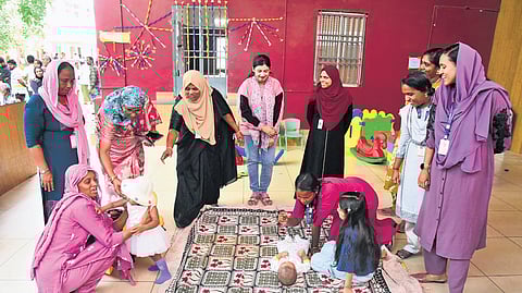 Anganwadi workers engaging children at the Women and Child-Friendly (Vanitha Shishu Souharda) booth at MMOVHSS School, Panayappally, Mattanchery.
