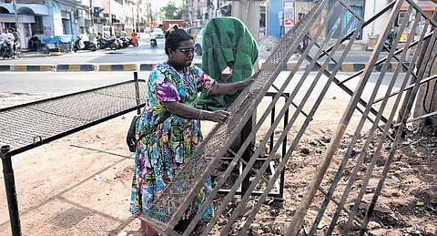 A vendor salvage scrap metal from the remnants of their shops that were demolished at Anand Bagh Chowrasta by the Malkajgiri Municipal Corporation.