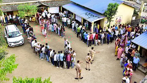 People wait in queues to cast their votes during the Assam Assembly elections, at a polling station at Bonda, in Guwahati, Thursday, April 9, 2026.