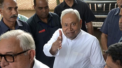Chief Minister Nitish Kumar greets upon arrival at his residence, in New Delhi on Thursday.