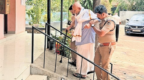 95-year-old K Madhavan Nair being assisted to the polling station at Jagathy Govt HS.