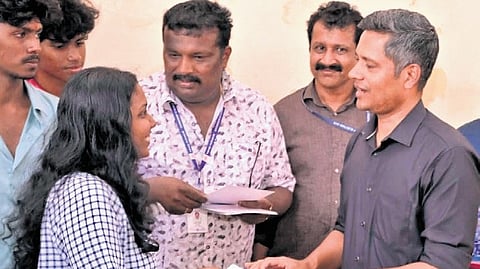 First-time voters receive halwa from Dr Rathan U Kelkar, CEO Kerala, after casting their votes in Thiruvananthapuram, as part of the ‘Vote Sweetened Kerala’ campaign