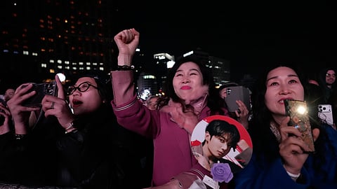 Fans react during a comeback concert of K-pop band BTS near Gwanghwamun Square in Seoul, South Korea, Saturday, March 21, 2026