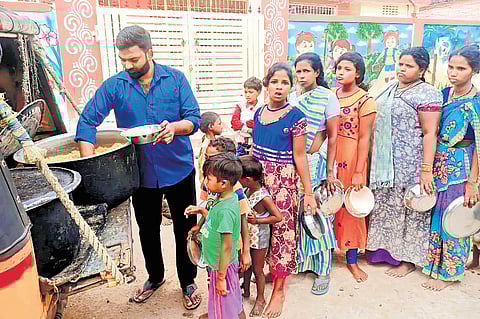 Bhargav Ventrapragada, founder of Helping Spot Organisation, serves food to children and women in Hyderabad