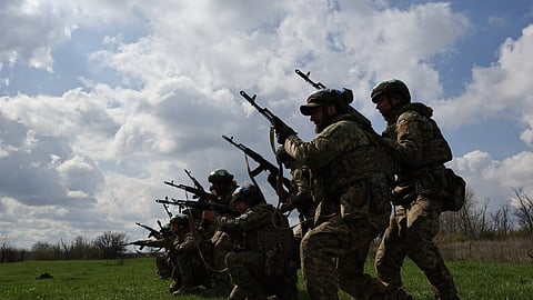 In this photo provided by Ukraine's 65th Mechanised Brigade press service on Wednesday, April 8, 2026, Ukrainian servicemen train in assault technique at the polygon in the Zaporizhzhia region, Ukraine.