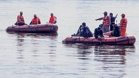 Rescue personnel during a search operation in the Yamuna river after a boat carrying pilgrims capsized on Friday, near Kesi Ghat, in Mathura district