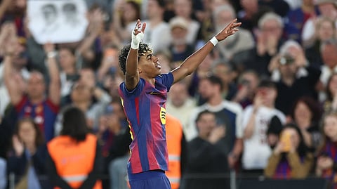 Barcelona's Spanish forward #10 Lamine Yamal celebrates scoring his team's third goal during the Spanish league football match between FC Barcelona and RCD Espanyol at the Camp Nou stadium in Barcelona on April 11 , 2026.